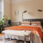 Small bedroom organisation with a tidy bed and light furniture