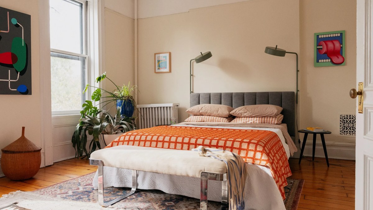 Small bedroom organisation with a tidy bed and light furniture
